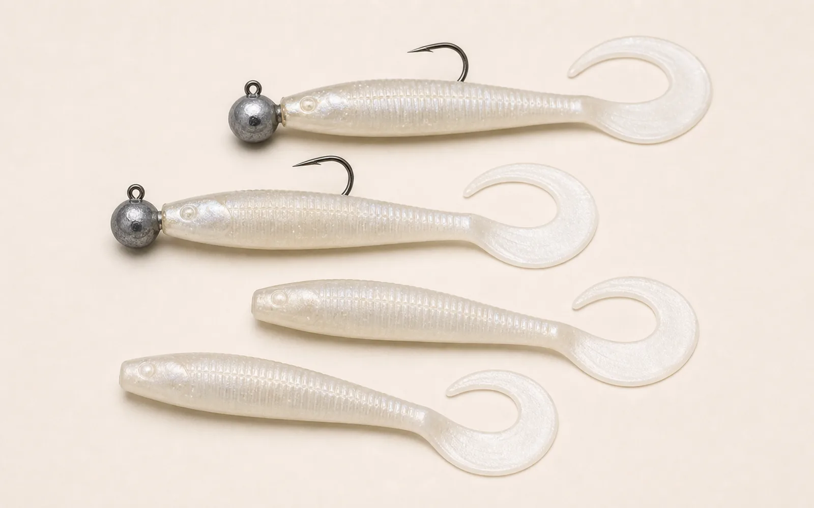 Pearl curly-tail swimming mullet soft baits rigged on round jigheads