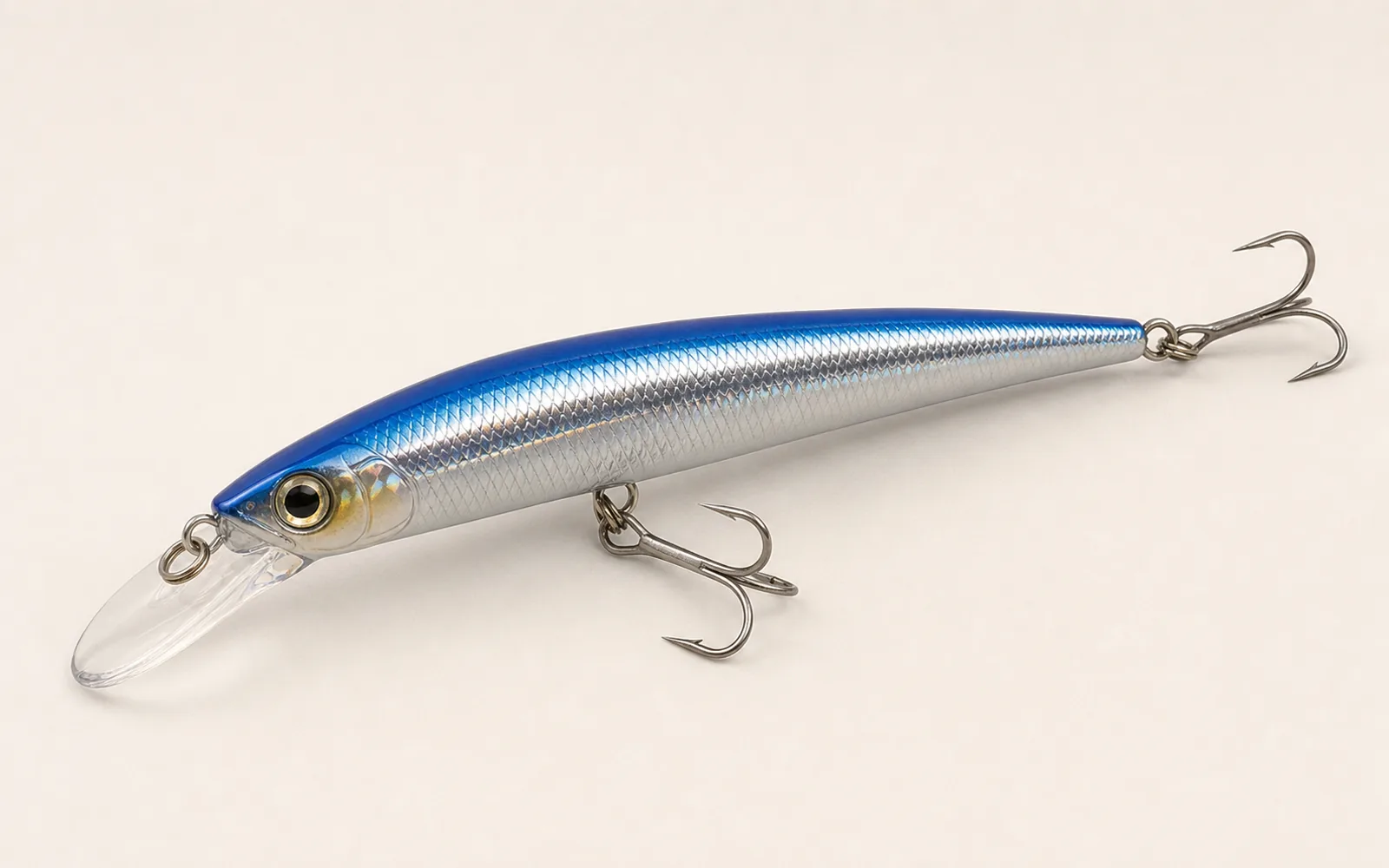 Long silver and blue minnow swimming plug with clear diving lip and treble hooks